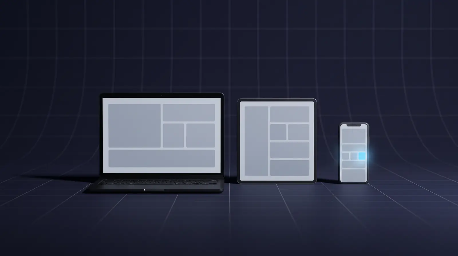 A laptop, a tablet and a phone in a row on a dark studio floor, all showing related layouts